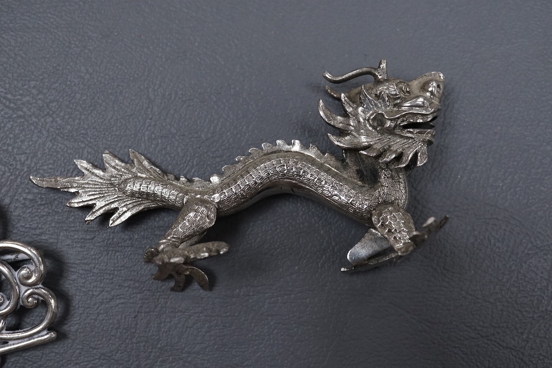 A group of small collectable silver including a white metal dragon menu holder? by Wang Hing, 92mm, two 19th century caddy spoons, three assorted belt buckles and a 1920's silver and enamel pill box(a.f), import marks fo